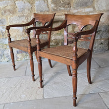 Load image into Gallery viewer, very-attractive-pair-19th-century-anglo-indian-colonial-armchairs-raffles-style-beautifully-hand-carved-teak-back-deep-shaped-crest-rails-scrolled-ends-reeded-mid-rails-down-swept-arms-baluster-shape-supports-caned-seats-fluted-legs-front-square-swept-legs-rear-attractive-comfortable-circa-1850-s-for-sale-damon-blandford-antiques-stow-on-the-wold