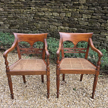 Load image into Gallery viewer, very-attractive-pair-19th-century-colonial-armchairs-raffles-style-beautifully-hand-carved-teak-back-deep-shaped-crest-rails-scrolled-ends-reeded-mid-rails-down-swept-arms-baluster-shape-supports-caned-seats-fluted-legs-front-square-swept-legs-rear-attractive-comfortable-circa-1850-s-for-sale-damon-blandford-antiques-stow-on-the-wold