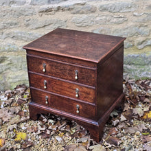 Load image into Gallery viewer, really-good-18th-century-early-oak-log-bin-small-faux-chest-three-drawers-moulded-lift-up-top-fitted-interior-removable-zinc-storage-bin-original-brass-drop-handles-bracket-feet-excellent-condition-good-colour-wear-velvet-seat-pad-informal-fireside-seat-for-sale-stow-on-the-wold-damon-blandford-antiques-cotswolds