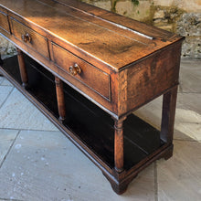 Load image into Gallery viewer, good-early-19th-century-welsh-oak-dresser-base-three-drawers-cock-beading-original-turned-wooden-drawer-pulls-apron-applied-moulded-edge-turned-supports-pot-board-bracket-feet-good-colour-excellent-condition-for-sale-damon-blandford-antiques-stow-on-the-wold-cotswolds
