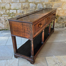 Load image into Gallery viewer, good-early-19th-century-welsh-oak-dresser-base-three-drawers-cock-beading-original-turned-wooden-drawer-pulls-apron-applied-moulded-edge-turned-supports-pot-board-bracket-feet-good-colour-excellent-condition-for-sale-damon-blandford-antiques-stow-on-the-wold-cotswolds