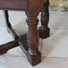 Load image into Gallery viewer, early-18th-century-credence-table-fabulous-patination-three-hundred-years-of-use-oval-shaped-walnut-top-drop-leaf-oak-base-three-baluster-shaped-legs-gate-leg-sanctuary-christian-worship-celebration-eucharist-remembrance-celebration-community-blacksmith-forged-hinges-important-ecclesiastical-furniture-characterful-useful-furniture-very-good-condition-side-occasional-table-english-circa-1725-for-sale-damon-blandford-antiques-stow-on-the-wold-cotswolds