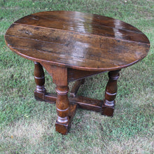 Load image into Gallery viewer, early-18th-century-credence-table-fabulous-patination-three-hundred-years-of-use-oval-shaped-walnut-top-drop-leaf-oak-base-three-baluster-shaped-legs-gate-leg-sanctuary-christian-worship-celebration-eucharist-remembrance-celebration-community-blacksmith-forged-hinges-important-ecclesiastical-furniture-characterful-useful-furniture-very-good-condition-side-occasional-table-english-circa-1725-for-sale-damon-blandford-antiques-stow-on-the-wold-cotswolds
