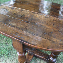 Load image into Gallery viewer, early-18th-century-credence-table-fabulous-patination-three-hundred-years-of-use-oval-shaped-walnut-top-drop-leaf-oak-base-three-baluster-shaped-legs-gate-leg-sanctuary-christian-worship-celebration-eucharist-remembrance-celebration-community-blacksmith-forged-hinges-important-ecclesiastical-furniture-characterful-useful-furniture-very-good-condition-side-occasional-table-english-circa-1725-for-sale-damon-blandford-antiques-stow-on-the-wold-cotswolds