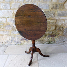 Load image into Gallery viewer, good-colour-18th-century-George-III -tripod-table-constructed-oak-circular-three-plank-top-bird-cage-mechanism-rotate-tilt-vertical-position-storage-baluster-shaped-column-cabriole-legs-strengthened-original-wrought-iron bracket-underside-really-attractive-well-proportioned-provincial-tripod-table-very-stable-fully-functional-english-circa-1780-for-sale-damon-blandford-antiques-stow-on-the-wold-cotswolds-early-oak-furniture-interion-design-home-wine-occasional