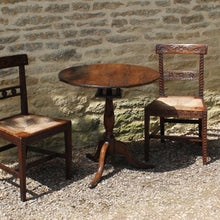 Load image into Gallery viewer, good-colour-18th-century-George-III -tripod-table-constructed-oak-circular-three-plank-top-bird-cage-mechanism-rotate-tilt-vertical-position-storage-baluster-shaped-column-cabriole-legs-strengthened-original-wrought-iron bracket-underside-really-attractive-well-proportioned-provincial-tripod-table-very-stable-fully-functional-english-circa-1780-for-sale-damon-blandford-antiques-stow-on-the-wold-cotswolds-early-oak-furniture-interion-design-home-wine-occasional