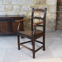 Load image into Gallery viewer, good-colour-early-19th-century-elm-open-armchair-originating-from-north-wales-square-styles-rails-stepped-top-rail-decorative-middle-rail-with-central-roundal-between-two-serpentine-shaped-elements-serpentine-shape-arms-arm-supports-decorative-chair-two-plank-elm-seat-square-legs-united-by-stretchers-wonderful-patina-contrasting-black-golden-honey-colours-particularly-attractive-traditional-contemporary-for-sale-damon-blandford-antiques-stroud-stow-on-the-wold-cotswolds-regional-furniture