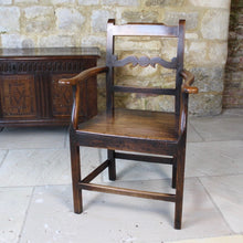 Load image into Gallery viewer, good-colour-early-19th-century-elm-open-armchair-originating-from-north-wales-square-styles-rails-stepped-top-rail-decorative-middle-rail-with-central-roundal-between-two-serpentine-shaped-elements-serpentine-shape-arms-arm-supports-decorative-chair-two-plank-elm-seat-square-legs-united-by-stretchers-wonderful-patina-contrasting-black-golden-honey-colours-particularly-attractive-traditional-contemporary-for-sale-damon-blandford-antiques-stroud-stow-on-the-wold-cotswolds-regional-furniture