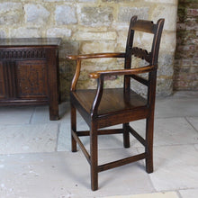 Load image into Gallery viewer, good-colour-early-19th-century-elm-open-armchair-originating-from-north-wales-square-styles-rails-stepped-top-rail-decorative-middle-rail-with-central-roundal-between-two-serpentine-shaped-elements-serpentine-shape-arms-arm-supports-decorative-chair-two-plank-elm-seat-square-legs-united-by-stretchers-wonderful-patina-contrasting-black-golden-honey-colours-particularly-attractive-traditional-contemporary-for-sale-damon-blandford-antiques-stroud-stow-on-the-wold-cotswolds-regional-furniture