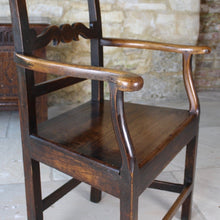 Load image into Gallery viewer, good-colour-early-19th-century-elm-open-armchair-originating-from-north-wales-square-styles-rails-stepped-top-rail-decorative-middle-rail-with-central-roundal-between-two-serpentine-shaped-elements-serpentine-shape-arms-arm-supports-decorative-chair-two-plank-elm-seat-square-legs-united-by-stretchers-wonderful-patina-contrasting-black-golden-honey-colours-particularly-attractive-traditional-contemporary-for-sale-damon-blandford-antiques-stroud-stow-on-the-wold-cotswolds-regional-furniture