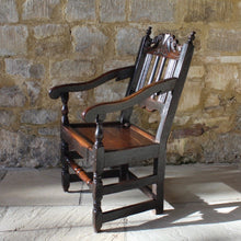 Load image into Gallery viewer, good-late-C17th-English-joined-oak-armchair-slat-back-good-angle-rake-particularly-comfortable-features-highly-decorative-well-carved-crest-rail-shaped-mid-rail-considerable-aesthetic-appeal-down-swept-arms-nicely-turned-supports-boarded-seat-turned-square-legs-stretchers-good-solid-condition-excellent-colour-beautifully-contrasting-black-gold-tones-for-sale-damon-blandford-antiques-stroud-stow-on-the-wold-early-oak-cotswold-country-house