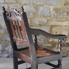 Load image into Gallery viewer, good-late-C17th-English-joined-oak-armchair-slat-back-good-angle-rake-particularly-comfortable-features-highly-decorative-well-carved-crest-rail-shaped-mid-rail-considerable-aesthetic-appeal-down-swept-arms-nicely-turned-supports-boarded-seat-turned-square-legs-stretchers-good-solid-condition-excellent-colour-beautifully-contrasting-black-gold-tones-for-sale-damon-blandford-antiques-stroud-stow-on-the-wold-early-oak-cotswold-country-house
