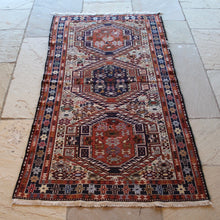 Load image into Gallery viewer, attractive-kilim-rug-hand-woven-loom-shahsevan-nomadic-people-tribe-northwestern-region-iran-design-features-three-large-central-medallions-cream-ground-surrounded-main-border-repeating-star-motifs-symbolising-happiness-fertility-stylised -bird-animal-motifs-predominantly-burnt-orange-cream-blue-colour-1960s-for-sale-damon-blandford-antiques-stroud-cotswolds-carpet-interior-floor