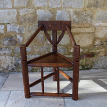 Load image into Gallery viewer, copy-of-the-old-saxon-chair-from-lord-leycesters-hospital-warwick-chair-of-ttriangular-form-chip-carved-to-same-design-by-victorian-chair-maker-john-starkey-further-example-victoria-and-albert-museum-london-comfortable-excellent-original-condition-new-bespoke-velvet-cushion-for-sale-damon-blandford-antiques-stroud-cotswolds-seating