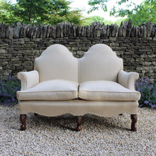 Load image into Gallery viewer, excellent-quality-two-seater-jacobean-revival-settee-generous-proportions-camel-back-scrolled-arms-loose-feather-cushion-seat-pads-shaped-frieze-carved-show-wood-legs-square-swept-legs-rear-beautifully-upholstered-high-quality-cream-green-colour-fabric-piped-edging-english-circa-1900-for-sale-damon-blandford-antiques-cotswolds-seating