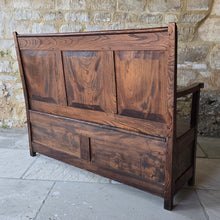 Load image into Gallery viewer, Good-colour-early-19th-century-box-settle-elm-back-rest-with-gentle-rake-three-panels-top-rail-carved-initials-J.I.A.I.-box-storage-section-bench-seat-arm-rests-square-supports-attractive-useful-furniture-hallway-boot-room-welsh-boarders-circa-1800-for-sale-damon-blandford-antiques-stow-on-the-wold-cotswolds