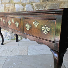 Load image into Gallery viewer, Excellent-quality-colour.mid-18th-century-oak-dresser-base-with-three-plank-top-moulded-edges-three-drawers- equal-length-plain-edges-brass-handles-escutcheons-fretwork-design-shapes-freeze-shapely-cabriole-legs-excellent-condition-for-sale-damon-blandford-antiques-cotswolds