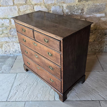 Load image into Gallery viewer, good-late-18th-century-oak-chest-of-drawers-constructed-from-well-figured-timbers-two-short-three-long-graduated-drawers-ovolo-moulding-original-brass-drop-handles-bracket-feet-good-colour-excellent-restored-condition-for-sale-damon-blandford-antiques-stroud-cotswolds-antique-furniture-storage