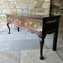 Load image into Gallery viewer, Excellent-quality-colour.mid-18th-century-oak-dresser-base-with-three-plank-top-moulded-edges-three-drawers- equal-length-plain-edges-brass-handles-escutcheons-fretwork-design-shapes-freeze-shapely-cabriole-legs-excellent-condition-for-sale-damon-blandford-antiques-cotswolds