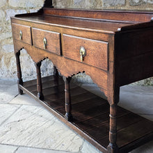 Load image into Gallery viewer, good-colour-georgian-welsh-oak-dresser-with-rack-constructed-from-well-figured-timbers-dresser-comprises-three-drawers-above-cupids-bow-shap- frieze-turned-supports-pot-board-excellent-condition-fresh-to-market-attractive-useful-furniture-south-wales-circa-1790-1810-good-original-condition-for-sale-damon-blandford-antiques-stow-on-the-wold