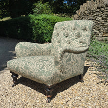 Load image into Gallery viewer, good-excellent-quality-mid-19th-century-armchair-upholstered-chair-shaped-button-back-curved-upholstered-arms-style-of-Howard-&-Sons-ebonised-turned-legs-brass-castors-black-ceramic-wheels-square-swept-legs-rear-incredibly-comfortable armchair-newly-re-upholstered-high-quality-printed-linen-featuring-bird-hare-motifs-attractive-for-sale-low-library-chair-damon-blandford-antiques-stow-on-the-wold-cotswolds