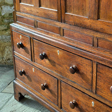 Load image into Gallery viewer, Good-well-proportioned-furniture-early19th- oak—court-cupboard-excellent-storage-top-section-canted-corners-spiral-design-flanking-ogee-panel-doors-shelf-moulded-cornice-mahogany-band-bottom-section-cock-bead-drawers-lined-pine-turned-wooden-drawer-pulls-bracket-feet-excellent-condition-good-warm-honey-colour-tones-North-West-Welsh-Borders-circa-1810-1820-for-sale-damon-blandford-antiques-stow-on-the-wold-early-oak