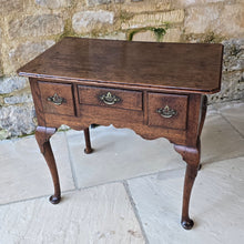 Load image into Gallery viewer, Good-colour-early-georgian-oak-side-table-lowboy-three-overlapping-drawers-ovolo-mouldings-retaining-original-brass-handles-shaped-frieze-cabriole-legs-pad-feet-solid-stable-condition-honest-attractive-useful-english-circa-1720s-for-sale-damon-blandford-antiques-stow-on-the-wold-cotswolds