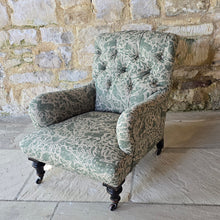 Load image into Gallery viewer, good-excellent-quality-mid-19th-century-armchair-upholstered-chair-shaped-button-back-curved-upholstered-arms-style-of-Howard-&-Sons-ebonised-turned-legs-brass-castors-black-ceramic-wheels-square-swept-legs-rear-incredibly-comfortable armchair-newly-re-upholstered-high-quality-printed-linen-featuring-bird-hare-motifs-attractive-for-sale-low-library-chair-damon-blandford-antiques-stow-on-the-wold-cotswolds