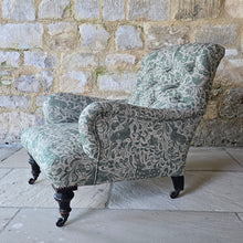 Load image into Gallery viewer, good-excellent-quality-mid-19th-century-armchair-upholstered-chair-shaped-button-back-curved-upholstered-arms-style-of-Howard-&-Sons-ebonised-turned-legs-brass-castors-black-ceramic-wheels-square-swept-legs-rear-incredibly-comfortable armchair-newly-re-upholstered-high-quality-printed-linen-featuring-bird-hare-motifs-attractive-for-sale-low-library-chair-damon-blandford-antiques-stow-on-the-wold-cotswolds