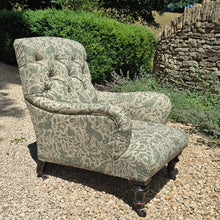 Load image into Gallery viewer, good-excellent-quality-mid-19th-century-armchair-upholstered-chair-shaped-button-back-curved-upholstered-arms-style-of-Howard-&-Sons-ebonised-turned-legs-brass-castors-black-ceramic-wheels-square-swept-legs-rear-incredibly-comfortable armchair-newly-re-upholstered-high-quality-printed-linen-featuring-bird-hare-motifs-attractive-for-sale-low-library-chair-damon-blandford-antiques-stow-on-the-wold-cotswolds