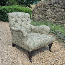 Load image into Gallery viewer, good-excellent-quality-mid-19th-century-armchair-upholstered-chair-shaped-button-back-curved-upholstered-arms-style-of-Howard-&-Sons-ebonised-turned-legs-brass-castors-black-ceramic-wheels-square-swept-legs-rear-incredibly-comfortable armchair-newly-re-upholstered-high-quality-printed-linen-featuring-bird-hare-motifs-attractive-for-sale-low-library-chair-damon-blandford-antiques-stow-on-the-wold-cotswolds