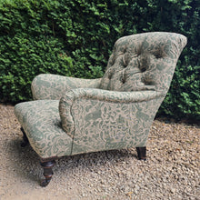 Load image into Gallery viewer, good-excellent-quality-mid-19th-century-armchair-upholstered-chair-shaped-button-back-curved-upholstered-arms-style-of-Howard-&-Sons-ebonised-turned-legs-brass-castors-black-ceramic-wheels-square-swept-legs-rear-incredibly-comfortable armchair-newly-re-upholstered-high-quality-printed-linen-featuring-bird-hare-motifs-attractive-for-sale-low-library-chair-damon-blandford-antiques-stow-on-the-wold-cotswolds