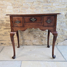 Load image into Gallery viewer, Good-colour-early-georgian-oak-side-table-lowboy-three-overlapping-drawers-ovolo-mouldings-retaining-original-brass-handles-shaped-frieze-cabriole-legs-pad-feet-solid-stable-condition-honest-attractive-useful-english-circa-1720s-for-sale-damon-blandford-antiques-stow-on-the-wold-cotswolds