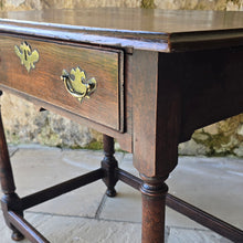 Load image into Gallery viewer, early-george-II-oak-side-table-exceptionally-good-colour-condition-overhung- top-ogee-moulding above-full-width-frieze-drawer-brass-handles-escutcheon-plate-well-turned-gun-barrel-legs-ring-turned-details-feet-outward-edged-stretches-english-circa-1730-for-sale-damon-blandford-antiques-stow-on-the-wold-cotswolds