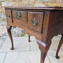 Load image into Gallery viewer, Good-colour-early-georgian-oak-side-table-lowboy-three-overlapping-drawers-ovolo-mouldings-retaining-original-brass-handles-shaped-frieze-cabriole-legs-pad-feet-solid-stable-condition-honest-attractive-useful-english-circa-1720s-for-sale-damon-blandford-antiques-stow-on-the-wold-cotswolds