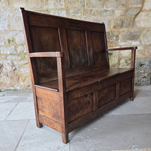 Load image into Gallery viewer, Good-colour-early-19th-century-box-settle-elm-back-rest-with-gentle-rake-three-panels-top-rail-carved-initials-J.I.A.I.-box-storage-section-bench-seat-arm-rests-square-supports-attractive-useful-furniture-hallway-boot-room-welsh-boarders-circa-1800-for-sale-damon-blandford-antiques-stow-on-the-wold-cotswolds