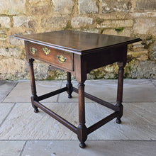 Load image into Gallery viewer, early-george-II-oak-side-table-exceptionally-good-colour-condition-overhung- top-ogee-moulding above-full-width-frieze-drawer-brass-handles-escutcheon-plate-well-turned-gun-barrel-legs-ring-turned-details-feet-outward-edged-stretches-english-circa-1730-for-sale-damon-blandford-antiques-stow-on-the-wold-cotswolds