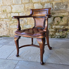 Load image into Gallery viewer, Excellent-condition-19th-century-bow-backed-elbow-captains-desk-chair-generous-proportions-incredibly-sturdy-constructed-in-oak-padded-tan-colour-hide-scroll-buttoned seat-raised-on-cabriole-legs-united-crinoline-stretcher.
Chair-very-well-constructed-noticeably-heavy-quality-timber-excellent-condition-age-related-wear-aesthetic-appeal-comfortable-supportive-large-desk-writing-table-good-quality-furniture-for-sale-damon-francis-blandford-stow-on-the-wold-cotswolds