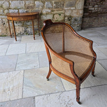 Load image into Gallery viewer, fine-19th-century-adam-style-bergère-arm-chair-generous-wide-deep-proportions-concave-arm-supports-square-tapered-swept-legs-brass-castors-satinwood-frame-painted-neo-classical-design-foliage-flowers-line-decoration-scrolled-crest-rail-young-lady-spaniel-cane-work-seat-back-rest-excellent-original-condition-good-vibrant-colours-excellent-example-aesthetic-appeal-for-sale-damon-blandford-antiques-stow-on-the-wold-cotswolds