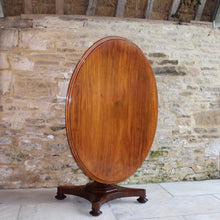 Load image into Gallery viewer, mahogany-tilt-top-table-wonderful-sun-bleached-oval-shape-top-baluster-shaped-pedestal-quadraform-base-damon-blandford-antiques-gloucestershire-cotswolds-for-sale-patina-golds-browns-reds-straw-colours-country-house-interiors-vintage-quality-timbers-breakfast-dinning-table