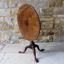 Load image into Gallery viewer, very-nice-george-III-third-mahogany-tilt-top-tripod-table-top-single-plank-mahogany-really-attractive-rim-carved-harlequin-design-repeated-tripod-legs-top-ring-turned-baluster-shape-pedestal-table-wonderful-patina-gold-red-colours-contrasting-darker-brown-black-appearance-created-really-good-decorative-highly-functional-tilt-top-table-damon-blandford-antiques-cotswolds-gloucestershire-stroud-for-sale-interior-design