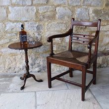 Load image into Gallery viewer, seat-chair-armchair-well-provincial-elm-chair-rush-seat-excellent-condition-good-colour-constructed-scrolled-chamfered-cross-rails-ball-decoration-well-figured-top-rail-scrolled-arm-rests-ring-turned-raised-square-tapered-legs-stretcher-elegant-design-wide-rush-seat-sloping-back-chair-comfortable-east-anglia-english-circa-1820-damon-blandford-antiques-jack-daniels-wine-table-gloucestershire-stroud-cotswolds-for-sale