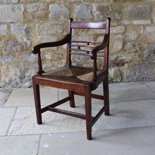 Load image into Gallery viewer, seat-chair-armchair-well-provincial-elm-chair-rush-seat-excellent-condition-good-colour-constructed-scrolled-chamfered-cross-rails-ball-decoration-well-figured-top-rail-scrolled-arm-rests-ring-turned-raised-square-tapered-legs-stretcher-elegant-design-wide-rush-seat-sloping-back-chair-comfortable-east-anglia-english-circa-1820-damon-blandford-antiques-gloucestershire-stroud-cotswolds-for-sale