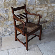 Load image into Gallery viewer, seat-chair-armchair-well-provincial-elm-chair-rush-seat-excellent-condition-good-colour-constructed-scrolled-chamfered-cross-rails-ball-decoration-well-figured-top-rail-scrolled-arm-rests-ring-turned-raised-square-tapered-legs-stretcher-elegant-design-wide-rush-seat-sloping-back-chair-comfortable-east-anglia-english-circa-1820-damon-blandford-antiques-gloucestershire-stroud-cotswolds-for-sale