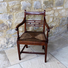 Load image into Gallery viewer, seat-chair-armchair-well-provincial-elm-chair-rush-seat-excellent-condition-good-colour-constructed-scrolled-chamfered-cross-rails-ball-decoration-well-figured-top-rail-scrolled-arm-rests-ring-turned-raised-square-tapered-legs-stretcher-elegant-design-wide-rush-seat-sloping-back-chair-comfortable-east-anglia-english-circa-1820-damon-blandford-antiques-gloucestershire-stroud-cotswolds-for-sale