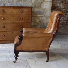 Load image into Gallery viewer, super-shape-leather-library-chair-third-quarter-19th-century-gently-reclining-scrolled-backrest-mahogany show-wood-frame-carved-lion-head-details-contrasting-beautifully-light-brown-tobacco-colour-leather-upholstery-sprung-seat-backrest-raised-well-proportioned-square-swept-legs-rear-turned-carved-legs-front-original-brass-cup-castors-porcelain-wheels-chair-real-presence-grandeur-damon-blandford-antiques-seating-upholstery-gloucestershire-cotswolds-interior-style-decoration-decorative-country-house-for-sale