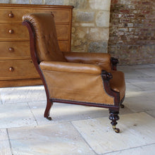 Load image into Gallery viewer, super-shape-leather-library-chair-third-quarter-19th-century-gently-reclining-scrolled-backrest-mahogany show-wood-frame-carved-lion-head-details-contrasting-beautifully-light-brown-tobacco-colour-leather-upholstery-sprung-seat-backrest-raised-well-proportioned-square-swept-legs-rear-turned-carved-legs-front-original-brass-cup-castors-porcelain-wheels-chair-real-presence-grandeur-damon-blandford-antiques-seating-upholstery-gloucestershire-cotswolds-interior-style-decoration-decorative-country-house-for-sale