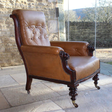 Load image into Gallery viewer, super-shape-leather-library-chair-third-quarter-19th-century-gently-reclining-scrolled-backrest-mahogany show-wood-frame-carved-lion-head-details-contrasting-beautifully-light-brown-tobacco-colour-leather-upholstery-sprung-seat-backrest-raised-well-proportioned-square-swept-legs-rear-turned-carved-legs-front-original-brass-cup-castors-porcelain-wheels-chair-real-presence-grandeur-damon-blandford-antiques-seating-upholstery-gloucestershire-cotswolds-interior-style-decoration-decorative-country-house-for-sale