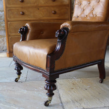 Load image into Gallery viewer, super-shape-leather-library-chair-third-quarter-19th-century-gently-reclining-scrolled-backrest-mahogany show-wood-frame-carved-lion-head-details-contrasting-beautifully-light-brown-tobacco-colour-leather-upholstery-sprung-seat-backrest-raised-well-proportioned-square-swept-legs-rear-turned-carved-legs-front-original-brass-cup-castors-porcelain-wheels-chair-real-presence-grandeur-damon-blandford-antiques-seating-upholstery-gloucestershire-cotswolds-interior-style-decoration-decorative-country-house-for-sale