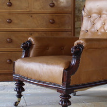 Load image into Gallery viewer, super-shape-leather-library-chair-third-quarter-19th-century-gently-reclining-scrolled-backrest-mahogany show-wood-frame-carved-lion-head-details-contrasting-beautifully-light-brown-tobacco-colour-leather-upholstery-sprung-seat-backrest-raised-well-proportioned-square-swept-legs-rear-turned-carved-legs-front-original-brass-cup-castors-porcelain-wheels-chair-real-presence-grandeur-damon-blandford-antiques-seating-upholstery-gloucestershire-cotswolds-interior-style-decoration-decorative-country-house-for-sale